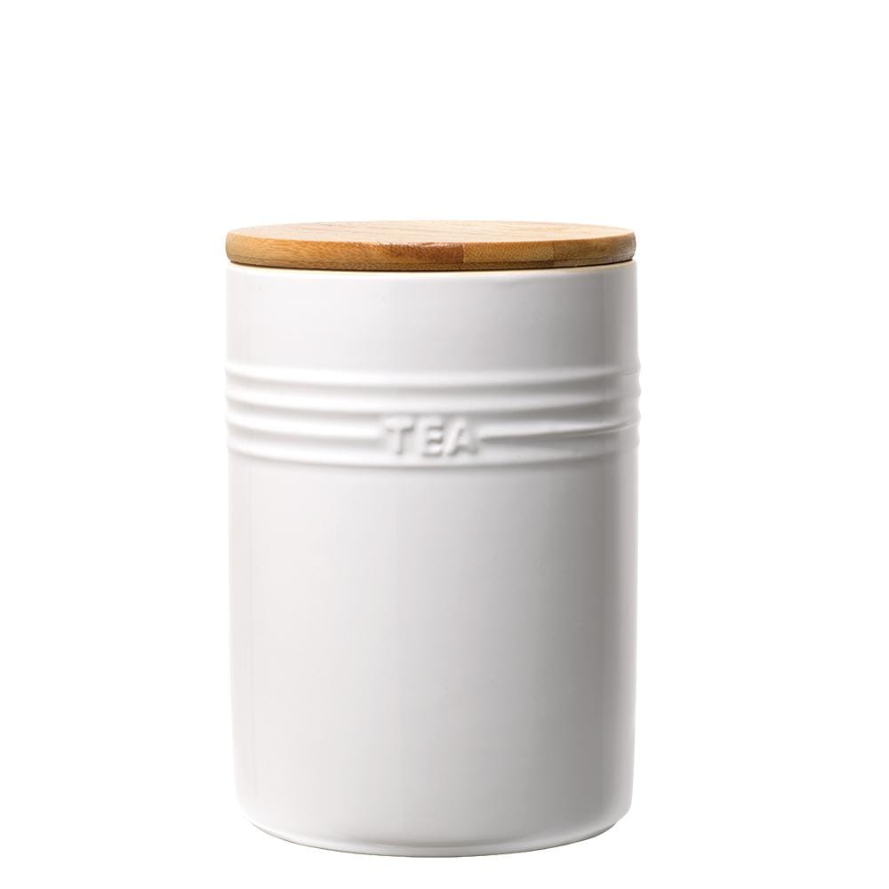A set of three white ceramic canisters with elegant lids and a sleek design - Baccarat
