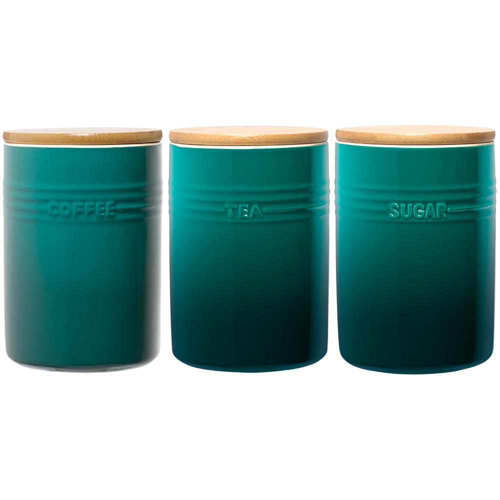 A stylish set of three cylindrical teal ceramic canisters with wooden lids - Baccarat