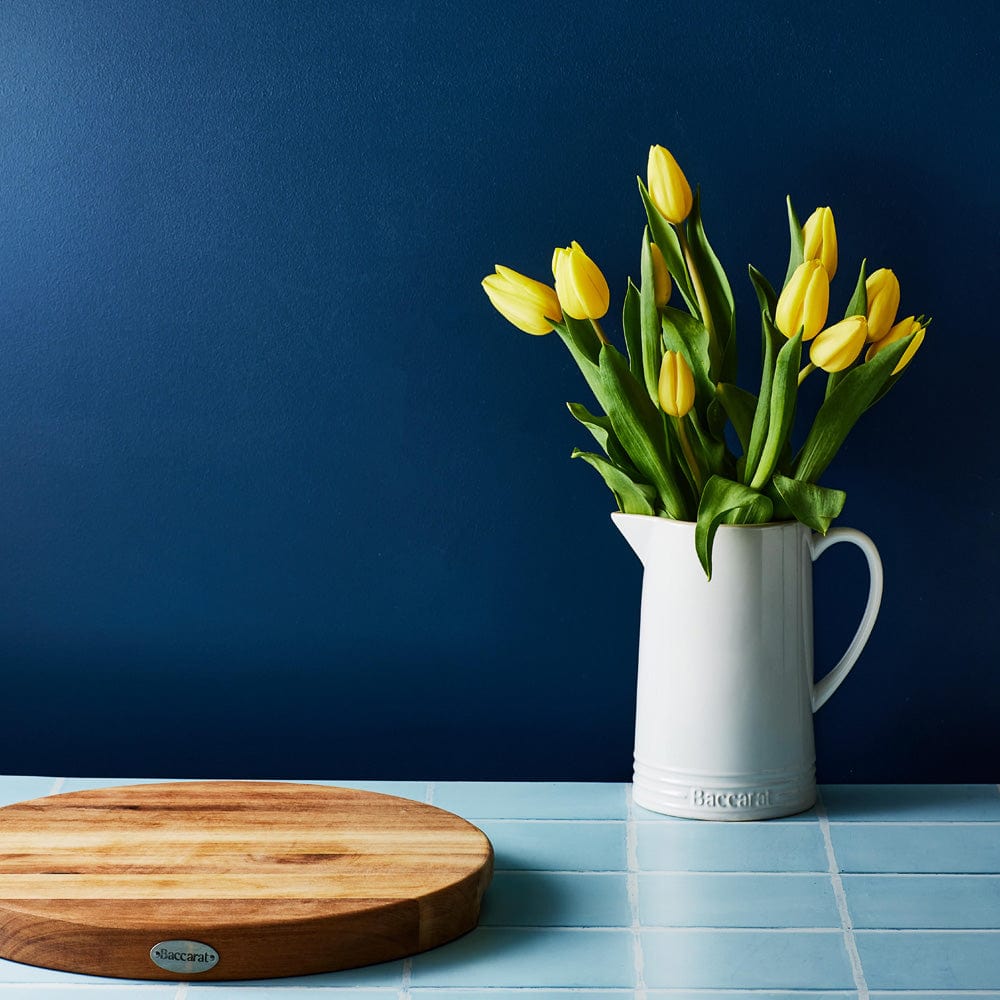 White stoneware jug filled with yellow tulips on blue table - Baccarat le connoisseur stoneware jug
