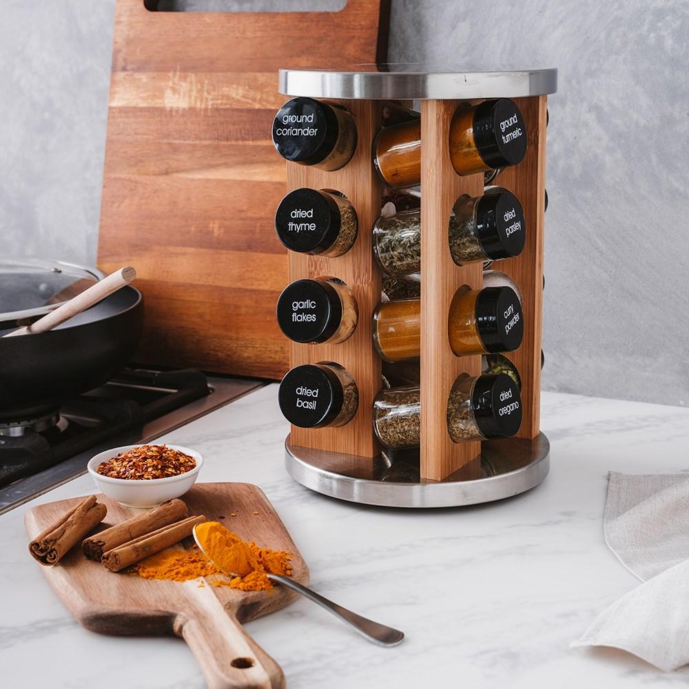 Stainless steel spice rack with 16 jars displaying vibrant spices on a kitchen countertop - Baccarat