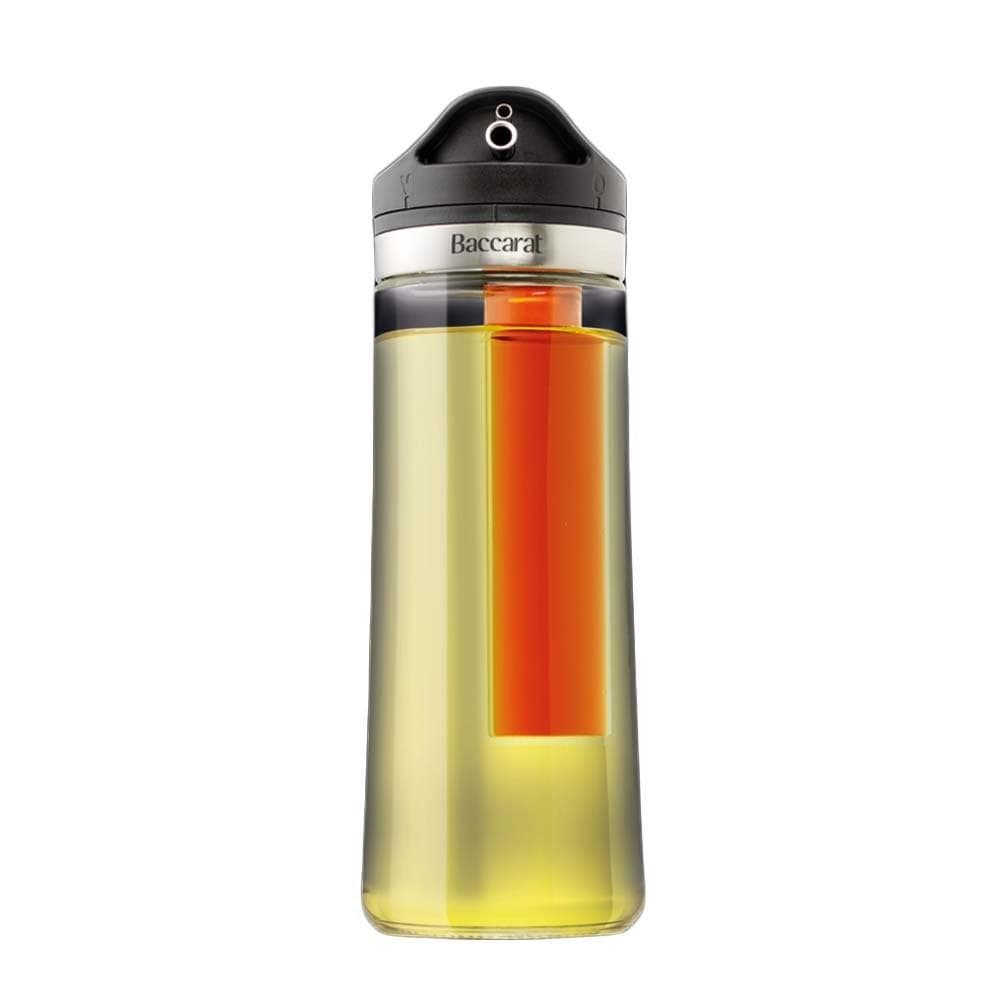 Pouring rich olive oil onto a vibrant kale salad with olives - Baccarat spice market oil and vinegar