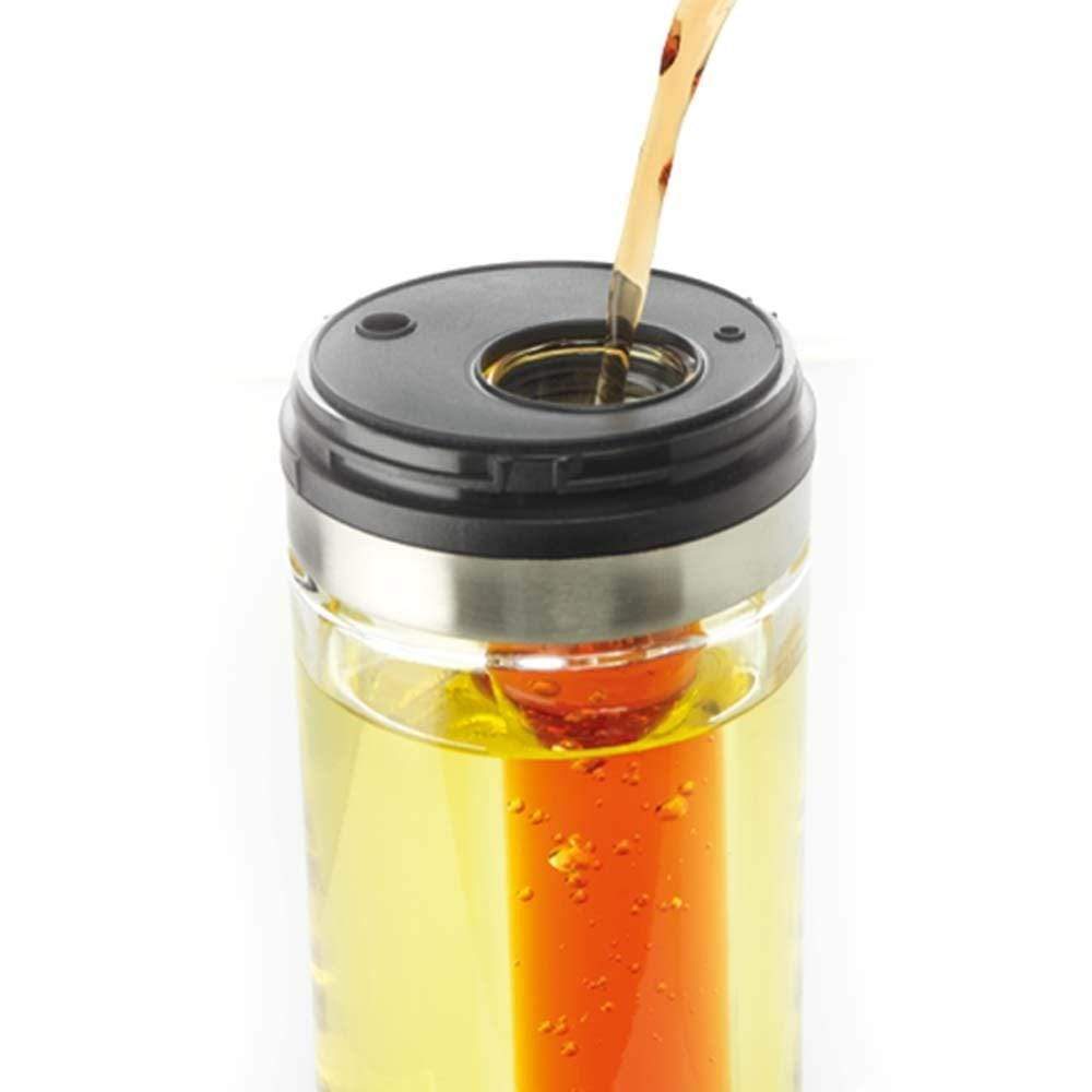 Pouring rich olive oil onto a vibrant kale salad with olives - Baccarat spice market oil and vinegar