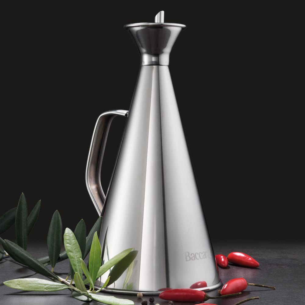 A polished stainless steel oil bottle elegantly drizzling golden olive oil - Baccarat spice market