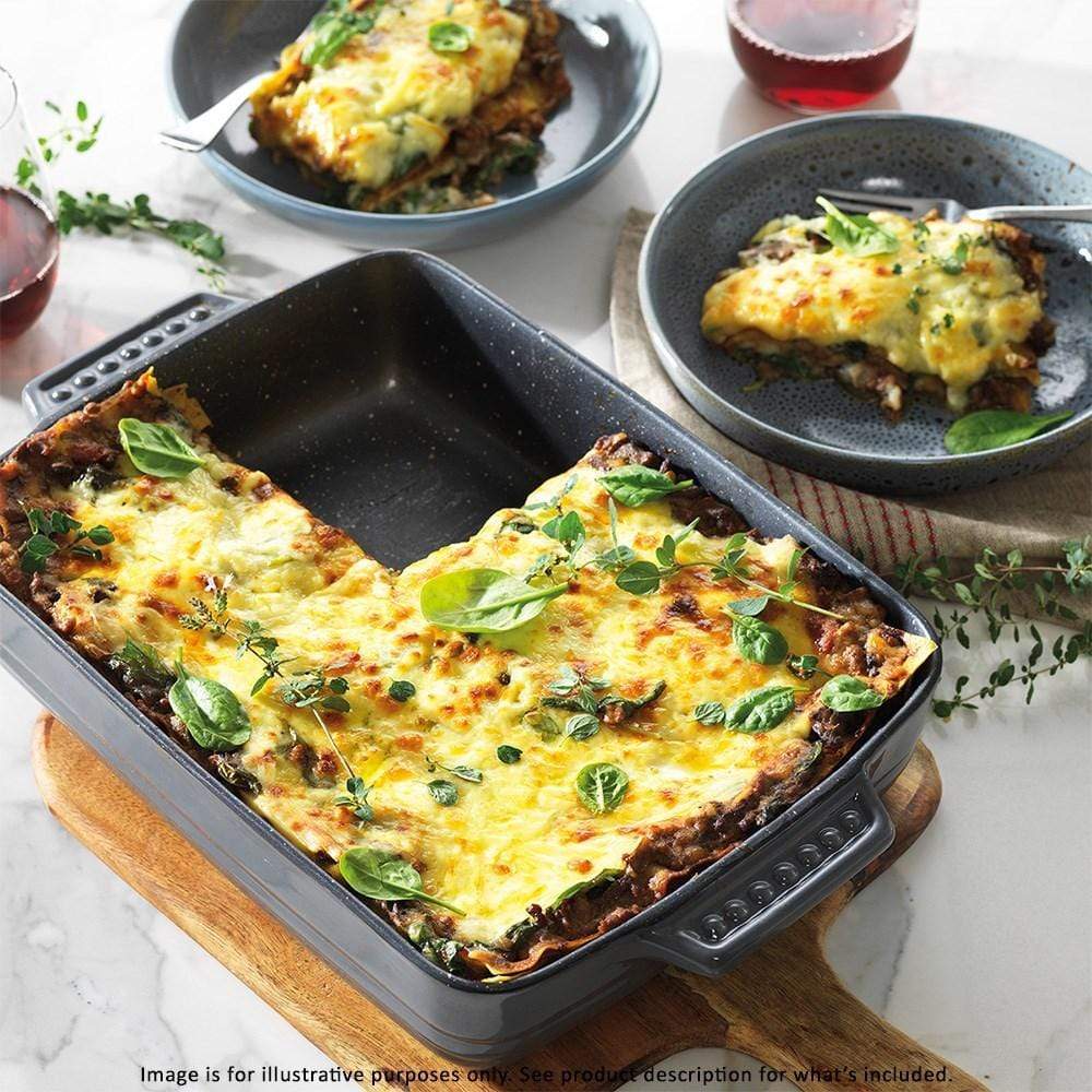 Golden lasagna with bubbling cheese and fresh basil in a non stick pan - Baccarat stone