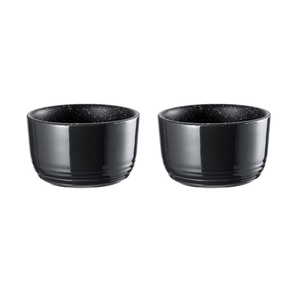two small ramekins filled with a breakfast of eggs tomatoes greens and beans - Baccarat stone