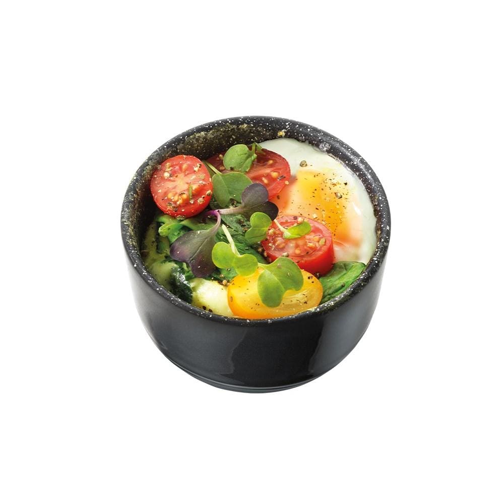 two small ramekins filled with a breakfast of eggs tomatoes greens and beans - Baccarat stone