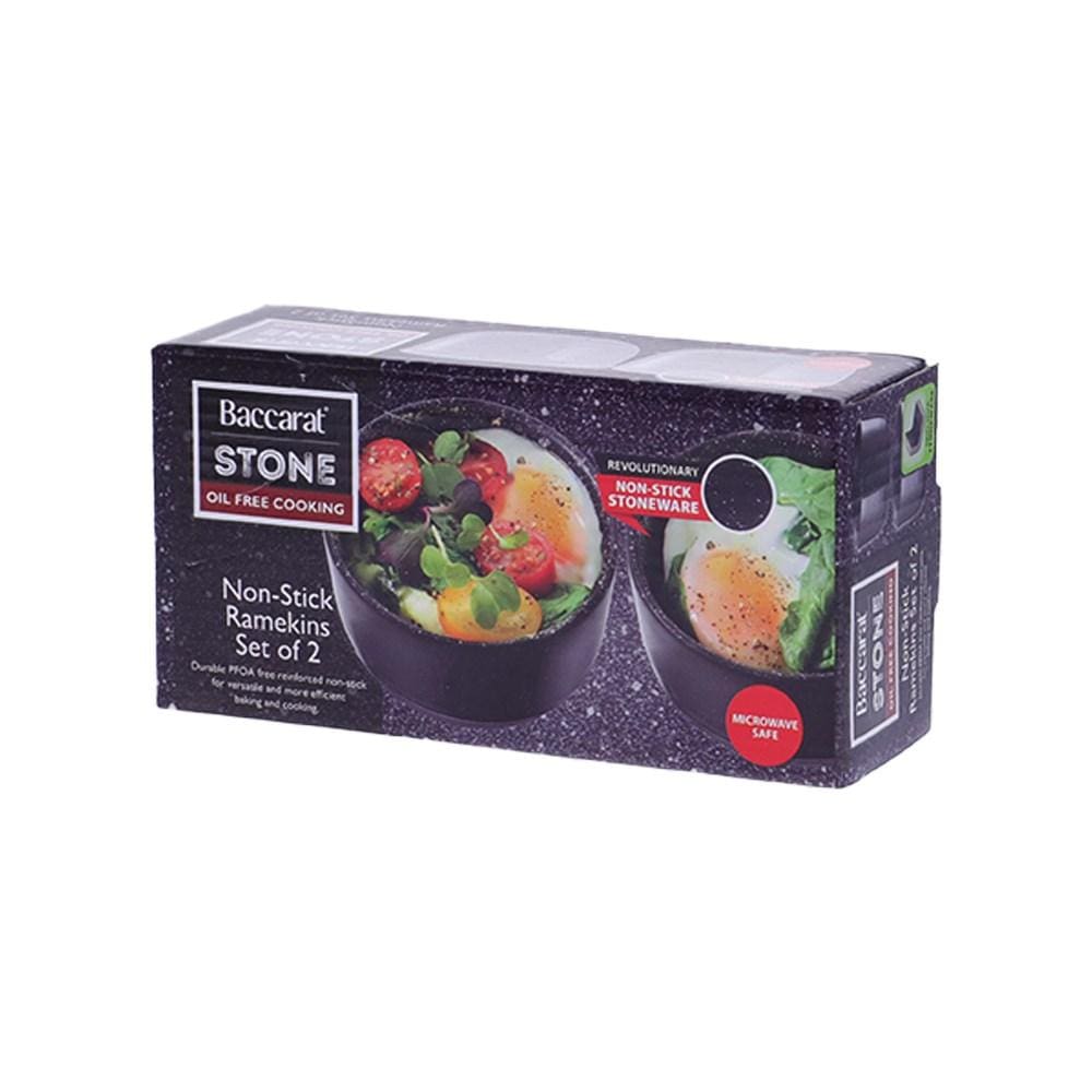 two small ramekins filled with a breakfast of eggs tomatoes greens and beans - Baccarat stone