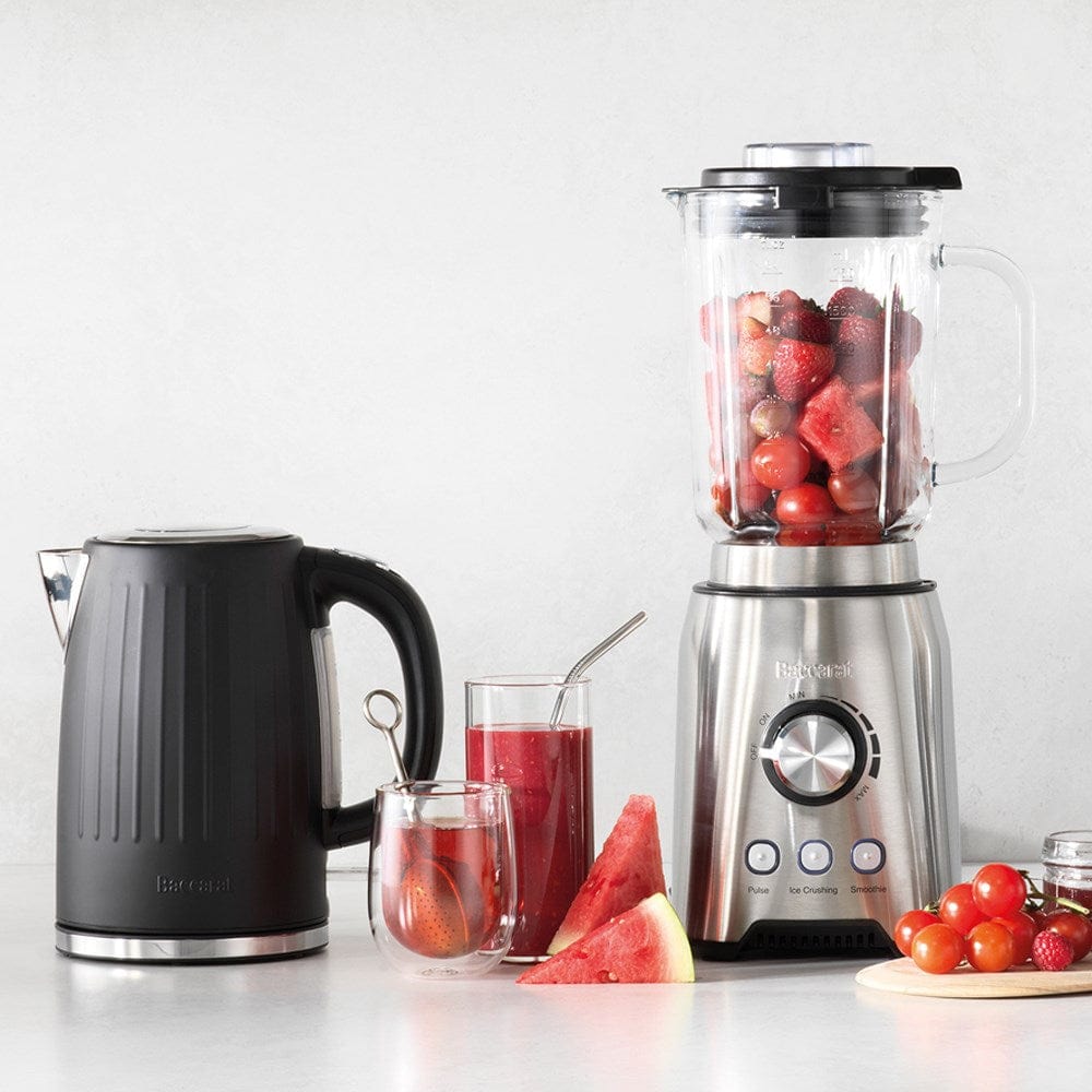 Black kettle pours hot water into a white cup beside a pastry plate - Baccarat Boiling Point Kettle