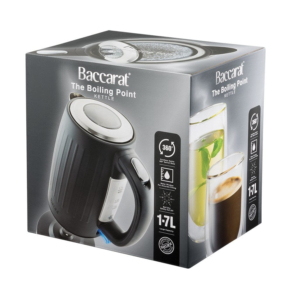 Black kettle pours hot water into a white cup beside a pastry plate - Baccarat Boiling Point Kettle