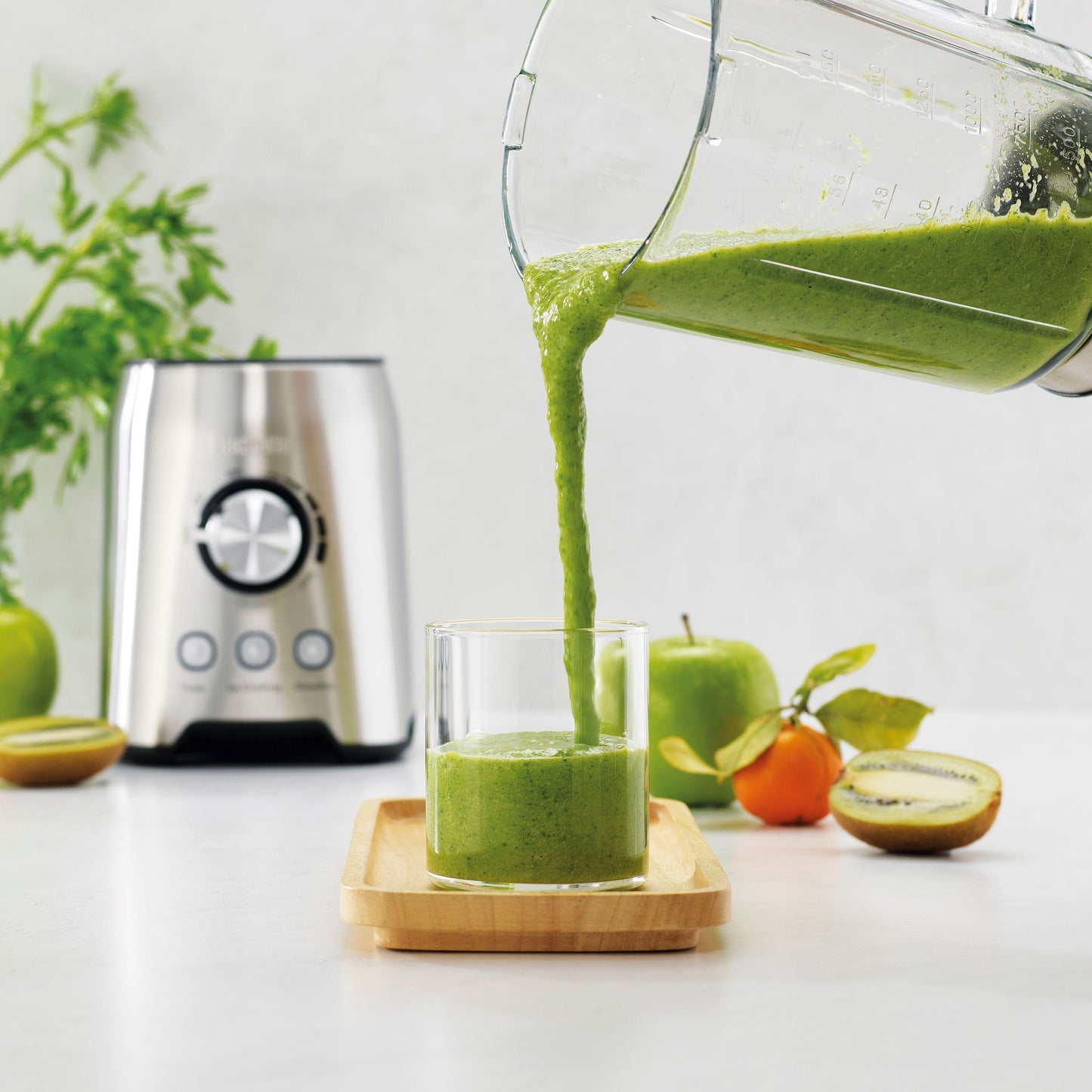 A vibrant countertop filled with fresh vegetables, produce and a powerful blender grinder - Baccarat