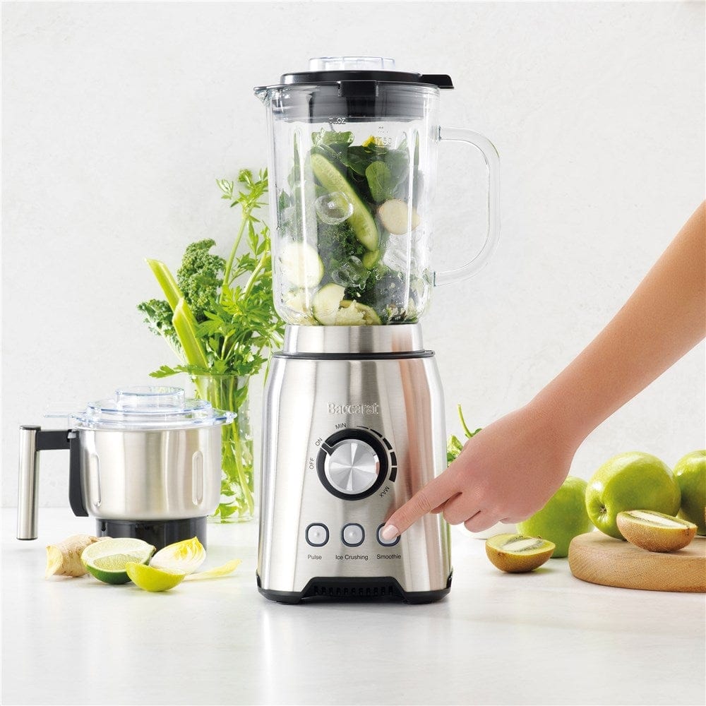 A vibrant countertop filled with fresh vegetables, produce and a powerful blender grinder - Baccarat