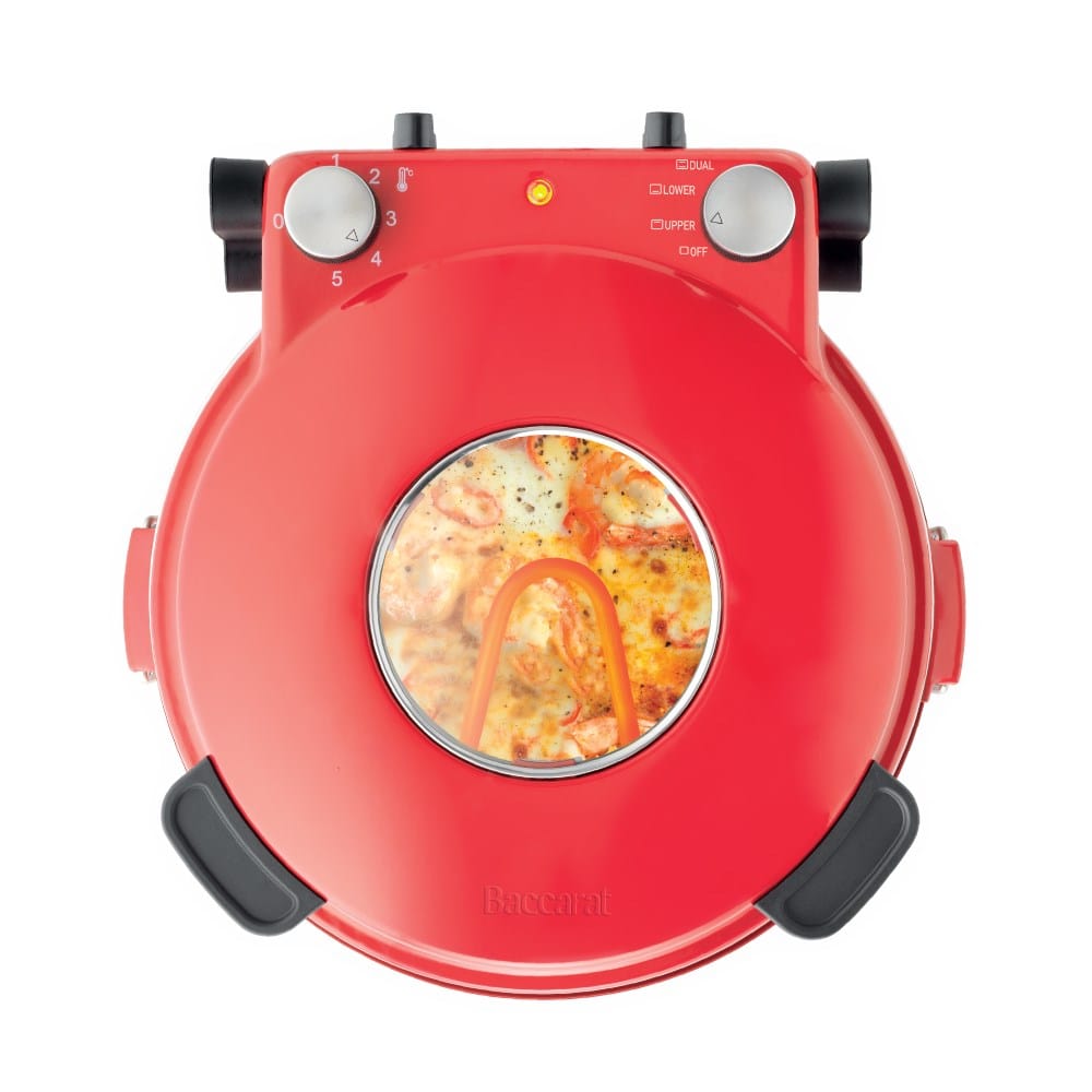 Red gourmet slice pizza oven with temperature dial beside a plant and tomato sauce bottle - Baccarat