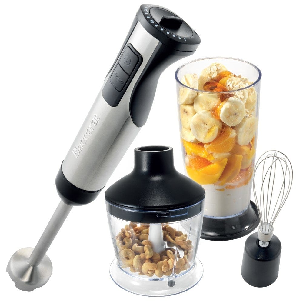 A yellow smoothie is blended surrounded by fresh fruits with a Baccarat The Quick Mix Stick Blender