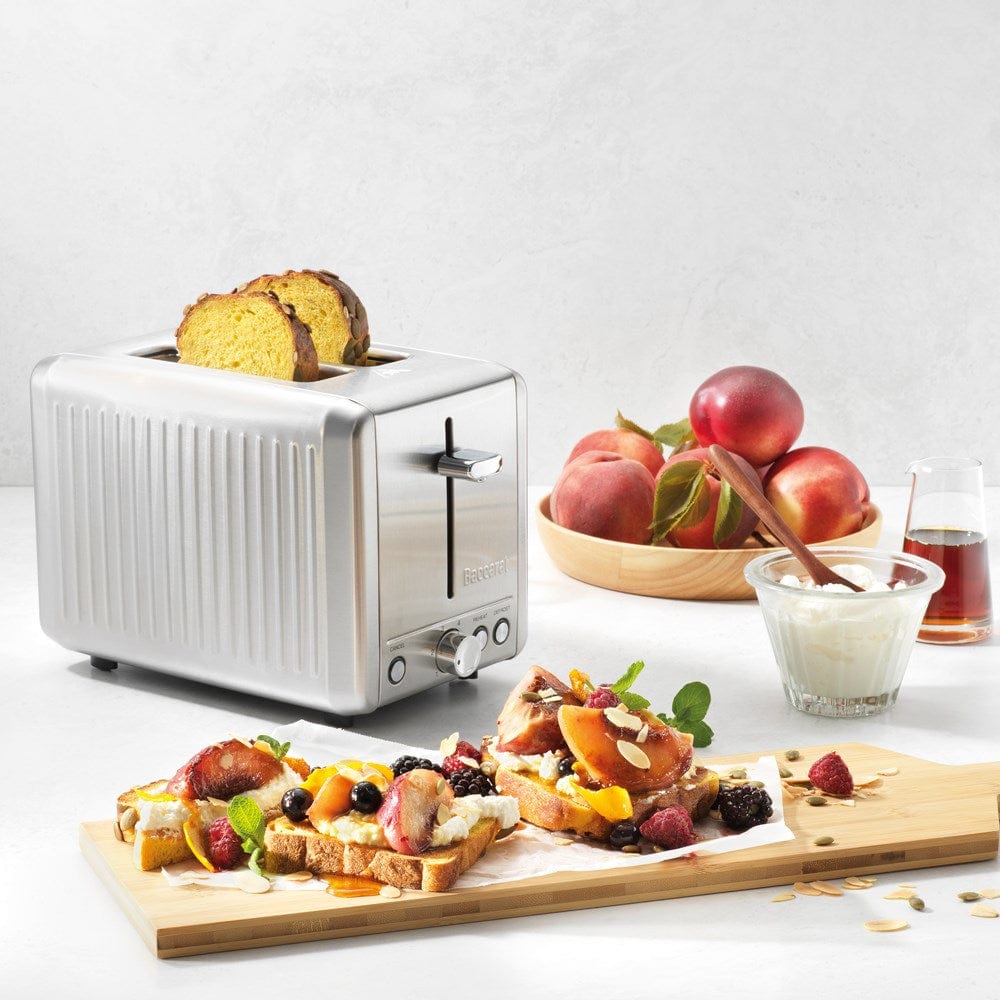 A stylish toaster with golden toast and fresh fruit in a bright kitchen silver toaster - Baccarat