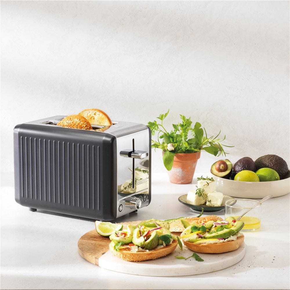 sleek black toaster surrounded by fresh bread and vibrant green avocados - Baccarat the toasty slice