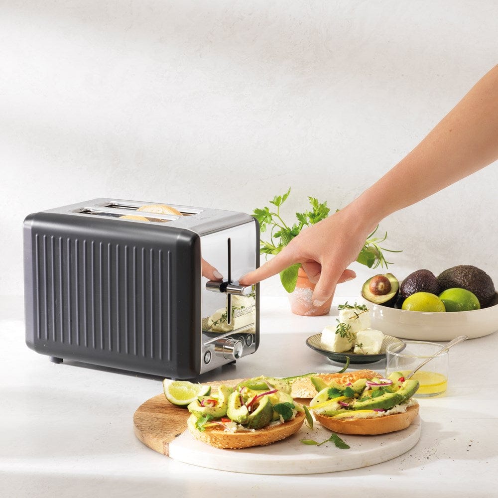 sleek black toaster surrounded by fresh bread and vibrant green avocados - Baccarat the toasty slice