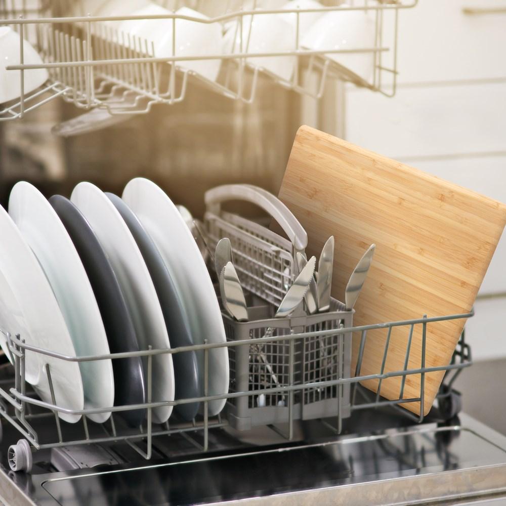Bamboo chopping board in natural colour with clean white plates and utensils - Baccarat