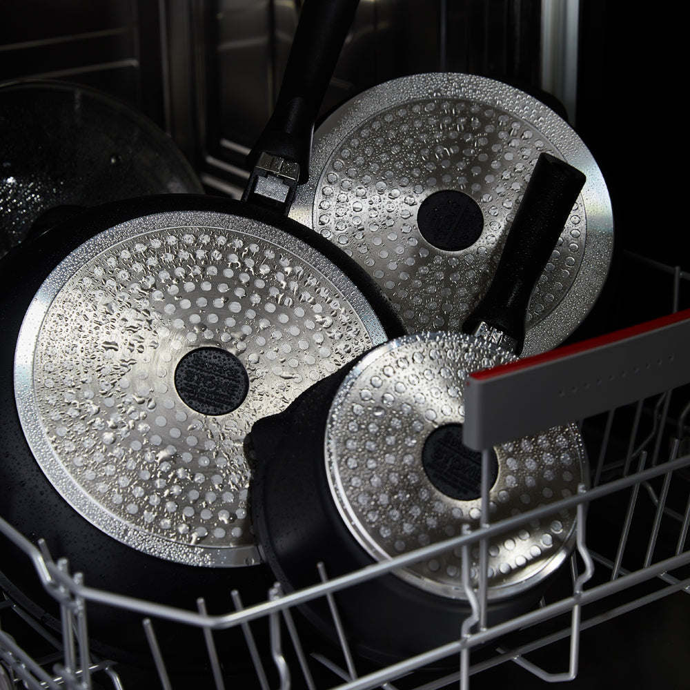 A complete cookware set with non-stick pans and pots featuring sleek black surfaces - Baccarat