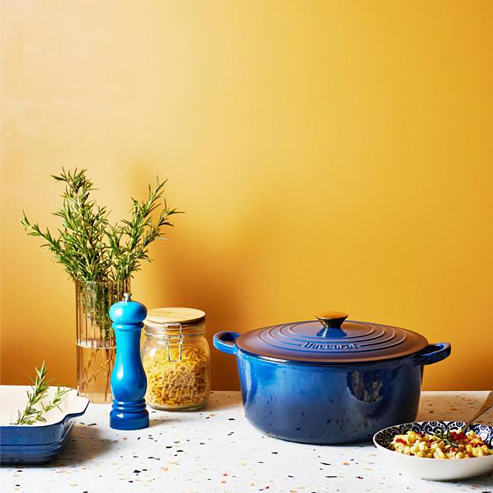 Blue Dutch oven and pepper mill on speckled counter - Baccarat Le Connoisseur