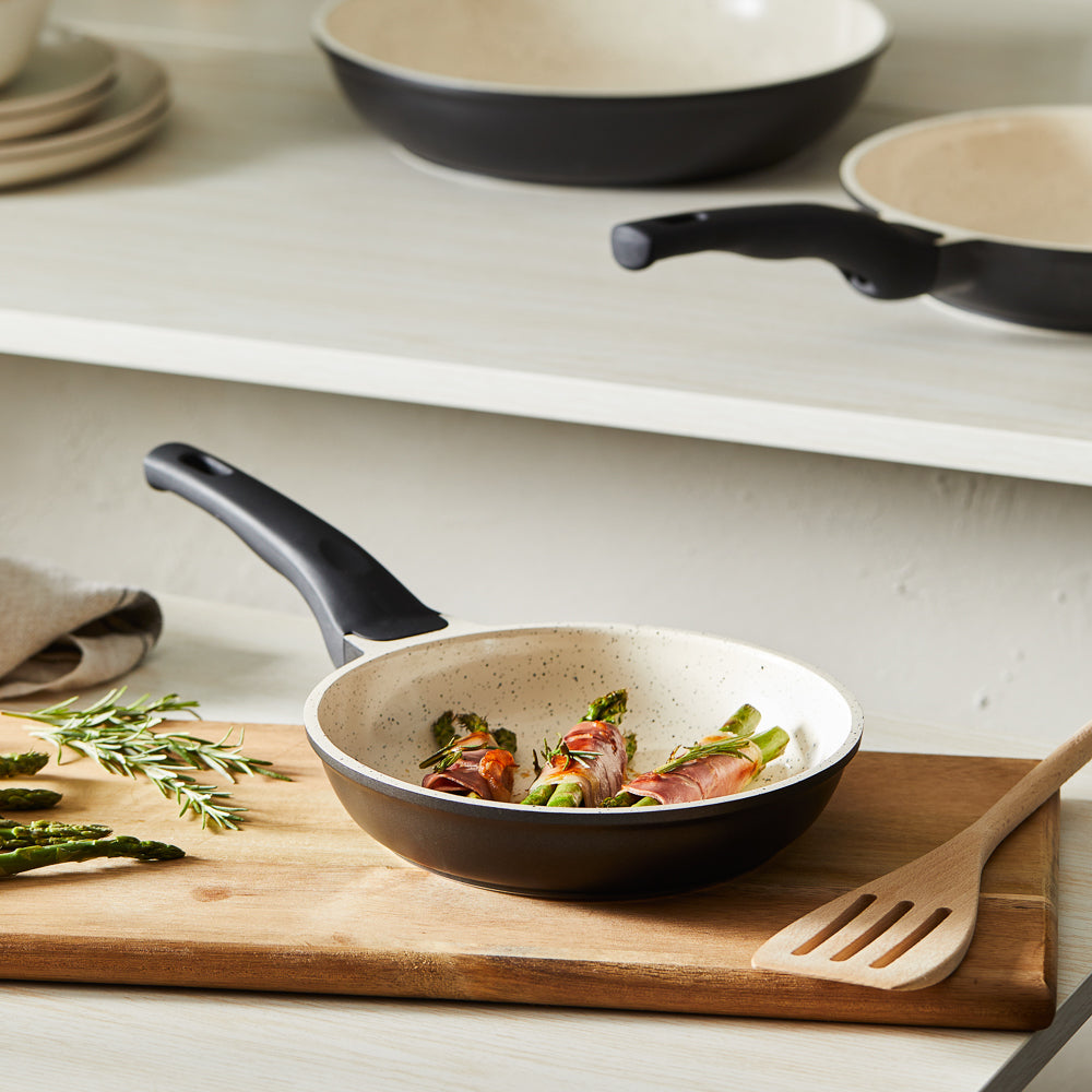 Three bundles of asparagus wrapped in prosciutto in a white fry pan - Baccarat ceramix fry pan 20cm