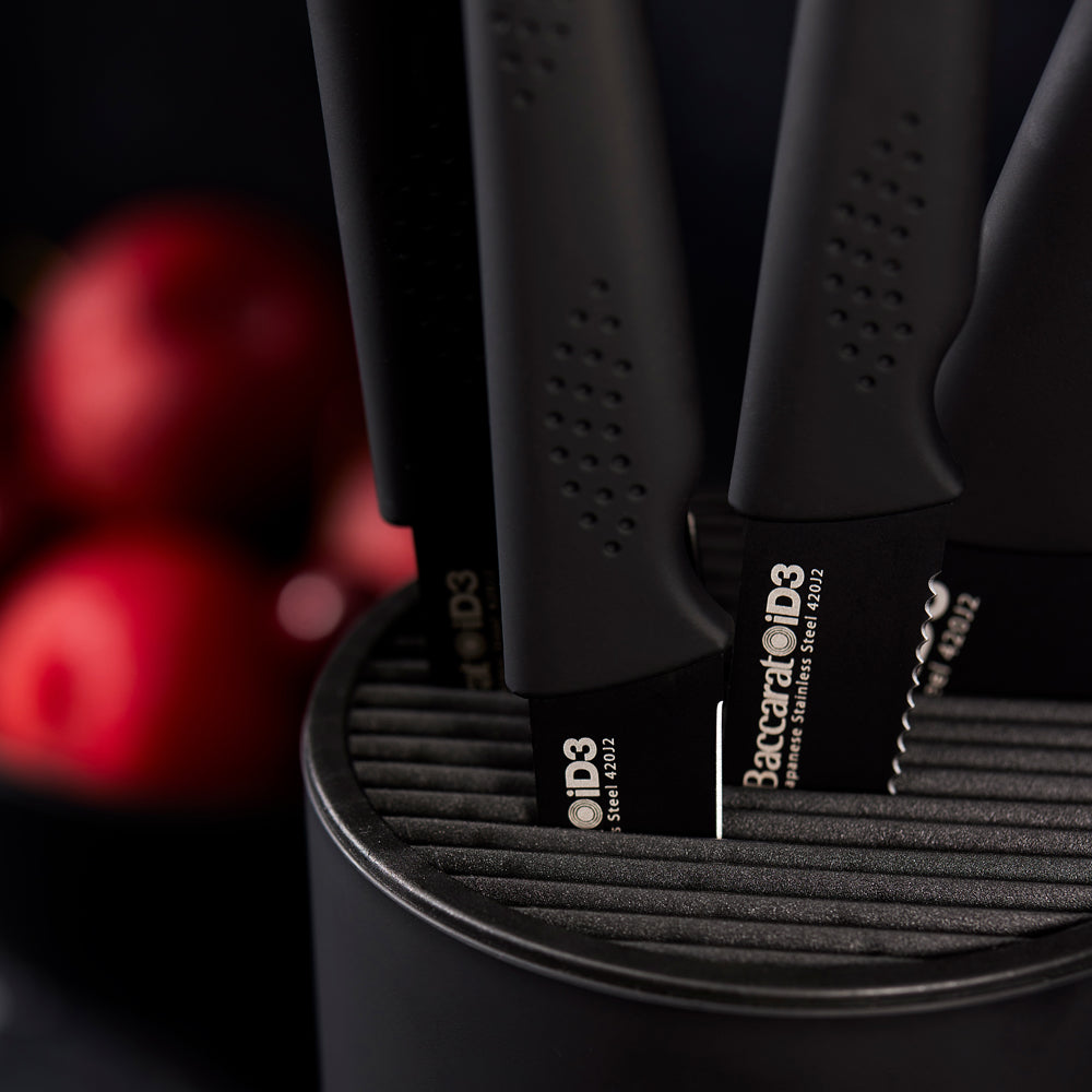 Stylish knife block with six sleek knives and vibrant apples in the background - Baccarat id3 kuro