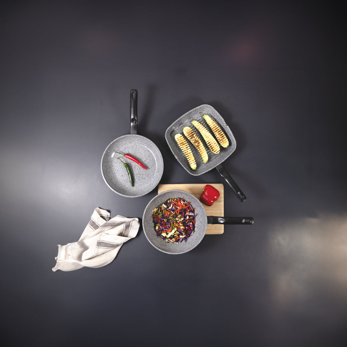 Set of cookware with food on a dark background