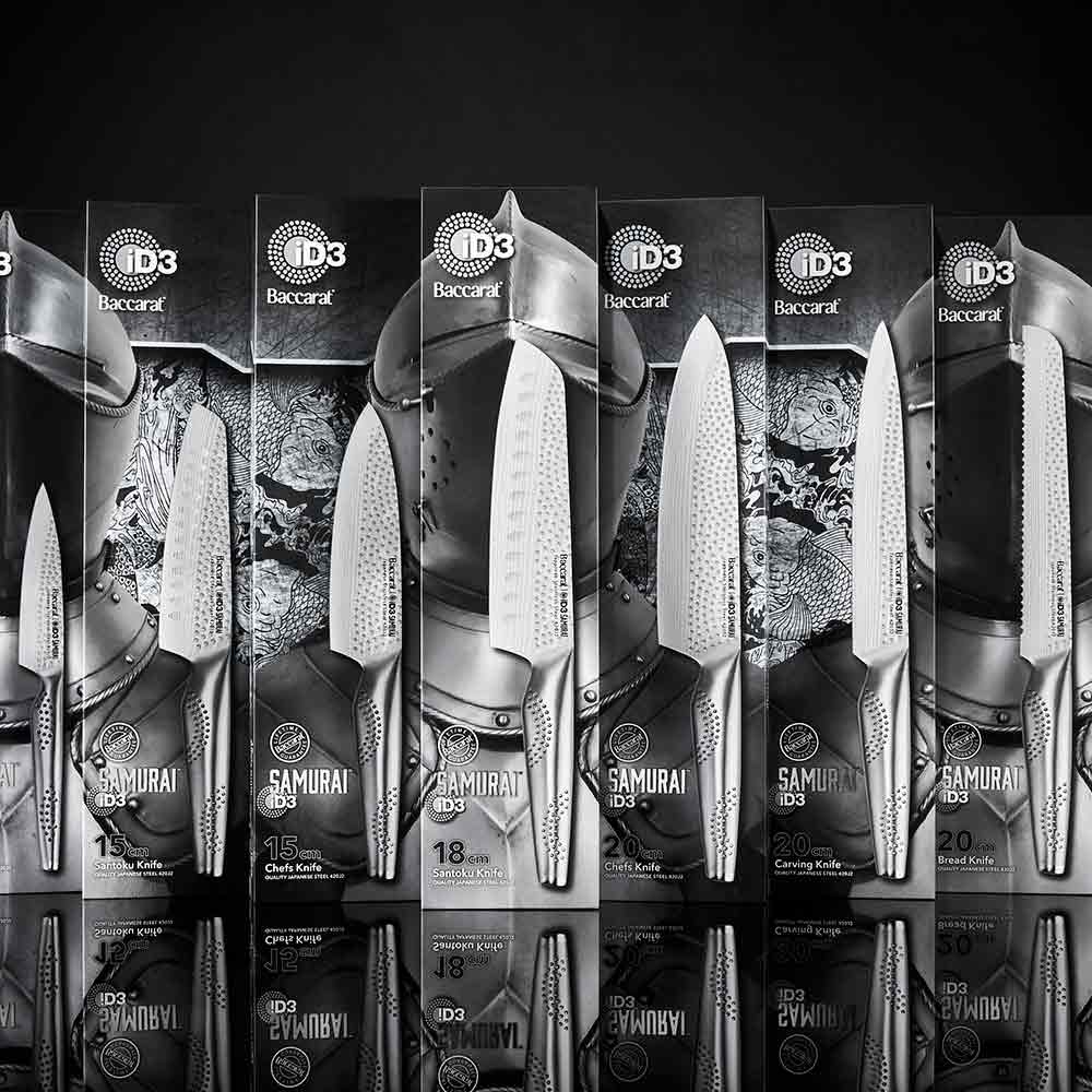 A sharp knife rests beside sliced raw fish on a slate board silver kitchen knife 20cm - Baccarat
