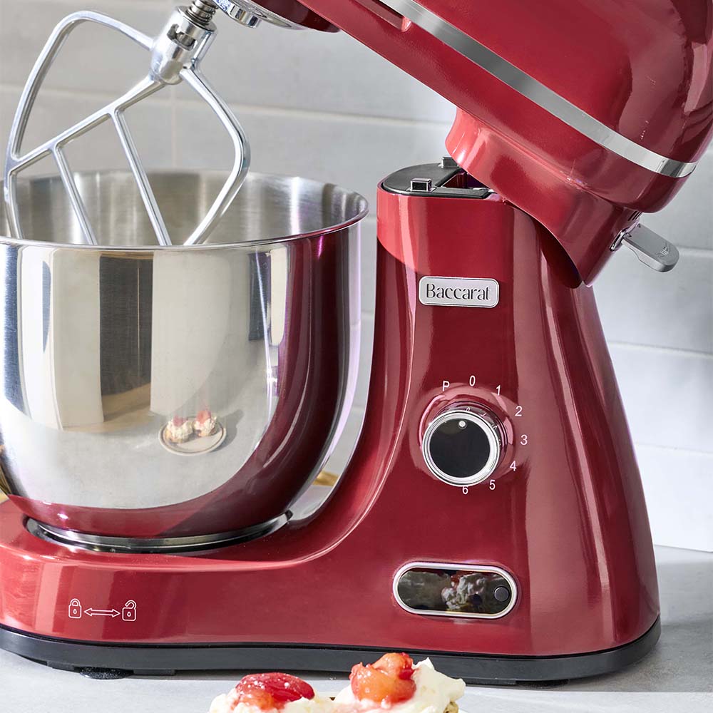 Red stand mixer with a silver bowl on a white surface