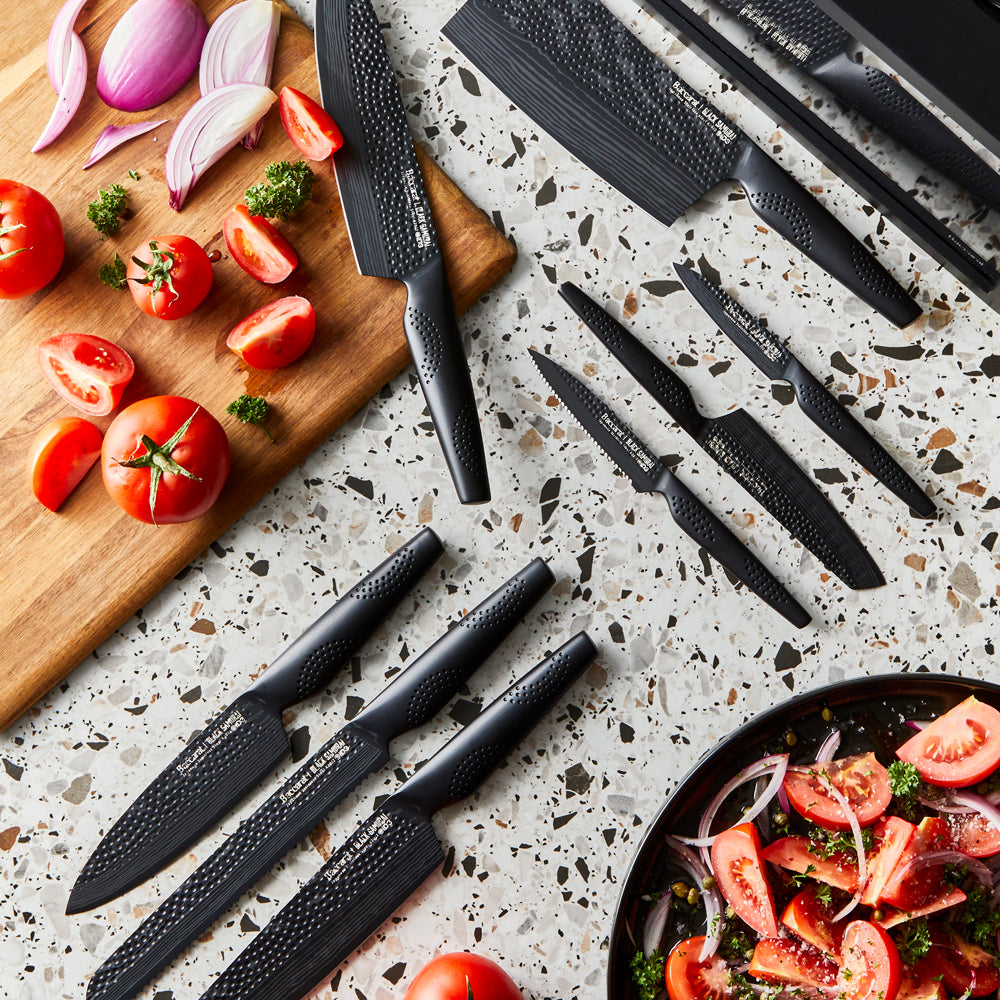 Sharp knives on speckled countertop with sliced tomatoes and onions - Baccarat id3 Black Samurai Syo