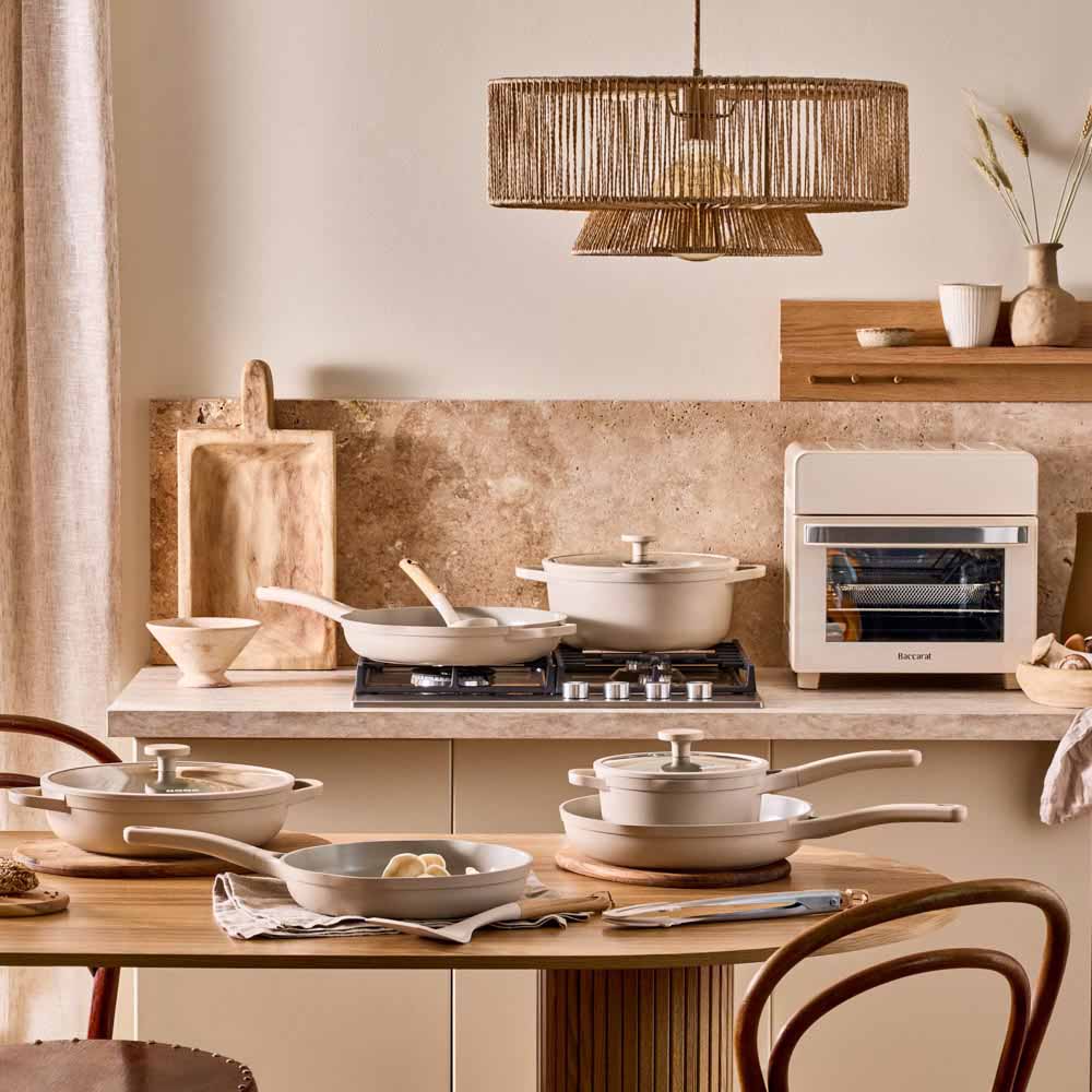 range of cream frypans, saucepans and utensils