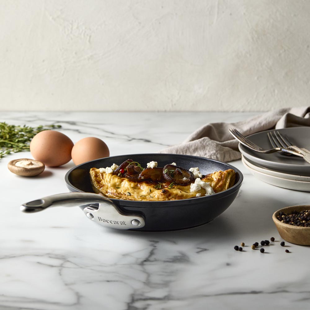 A sleek frying pan with a long handle black non-stick frying pan - Baccarat damashiro emperor makoto
