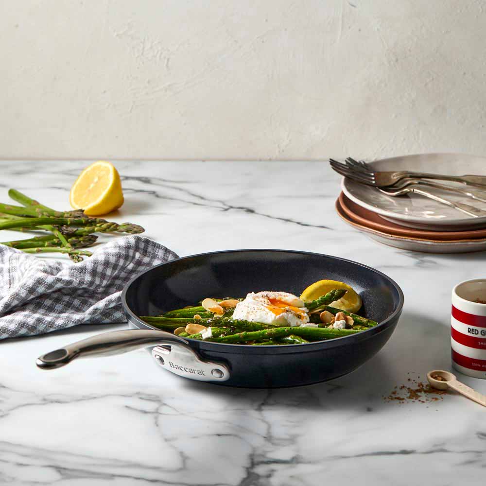 A non-stick frying pan with a sleek black surface and silver handle - Baccarat le connoisseur