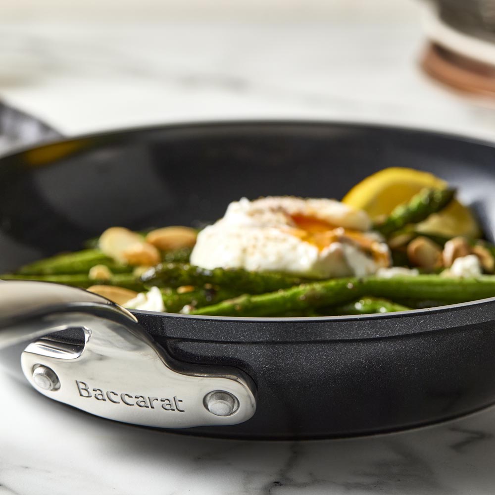 A non-stick frying pan with a sleek black surface and silver handle - Baccarat le connoisseur