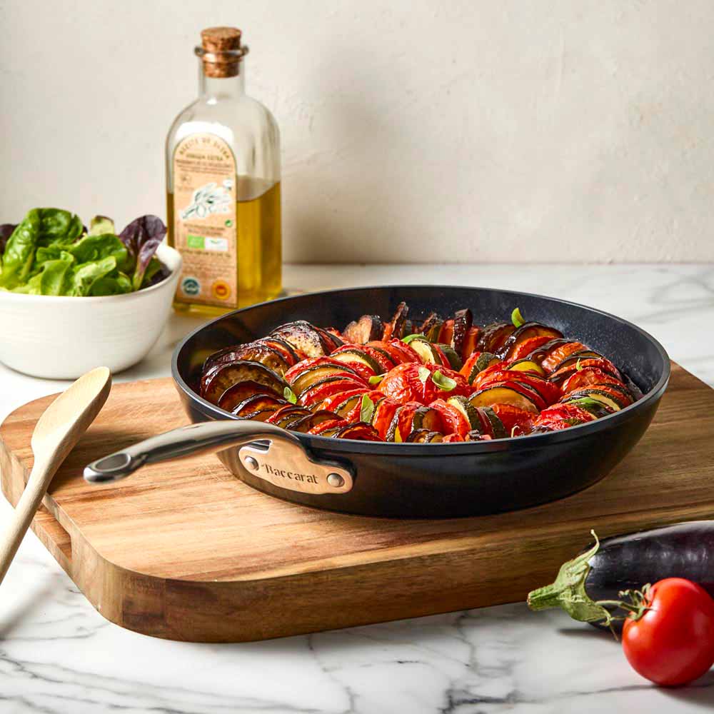 Close-up of a black cast iron skillet filled with vibrant ratatouille colour frypan 26cm - Baccarat