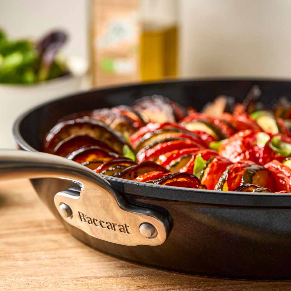 Close-up of a black cast iron skillet filled with vibrant ratatouille colour frypan 26cm - Baccarat
