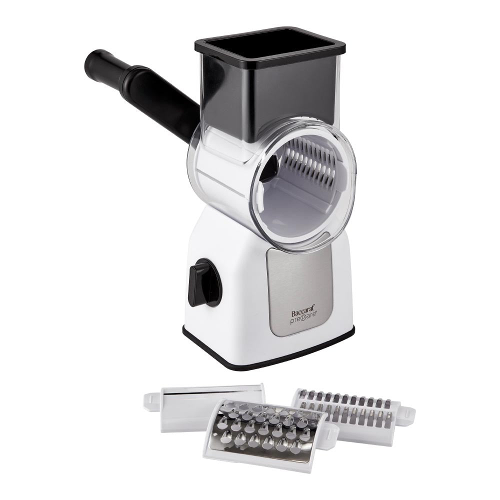 Colourful vegetables being sliced with a Baccarat Prepare Rotary Drum Grater and attachments beside