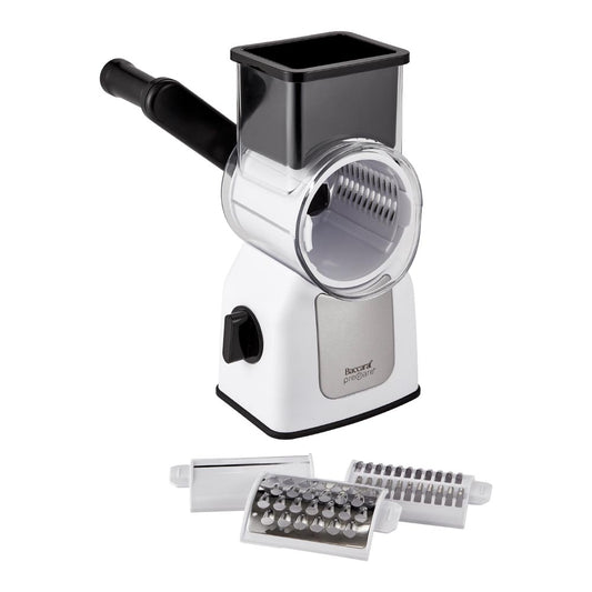 Colourful vegetables being sliced with a Baccarat Prepare Rotary Drum Grater and attachments beside