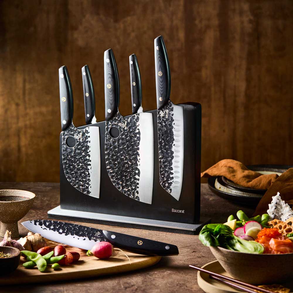Baccarat KUROI KIBA 7 Piece Knife Block on wooden bench with vegetables at Baccarat