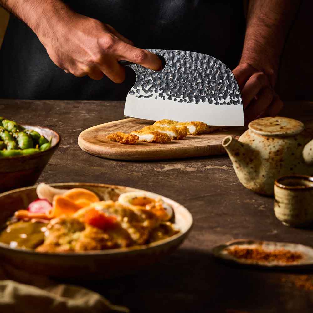 Man slicing katsu chicken with Baccarat KUROI KIBA Moon Knife 17.5cm at Baccarat