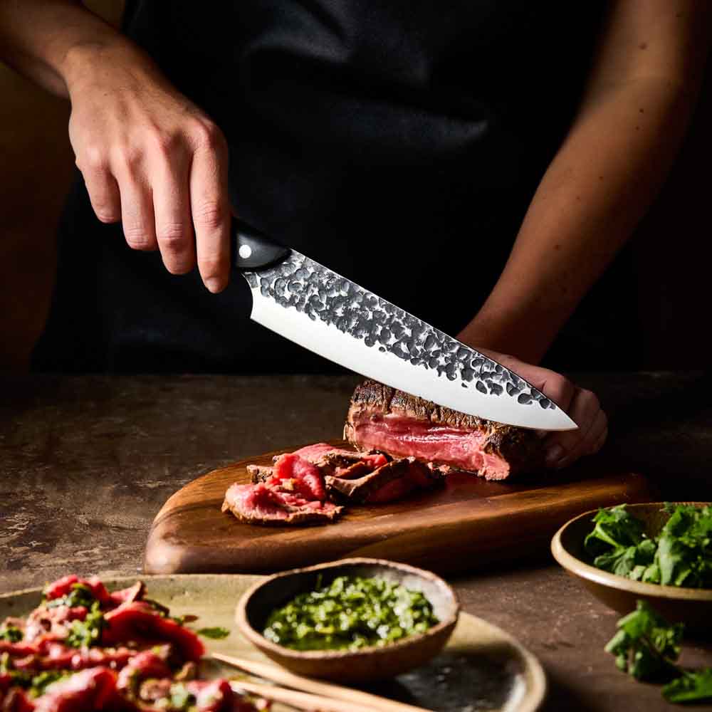 Man slicing wagyu beef with Baccarat KUROI KIBA Chefs Knife 20cm at Baccarat