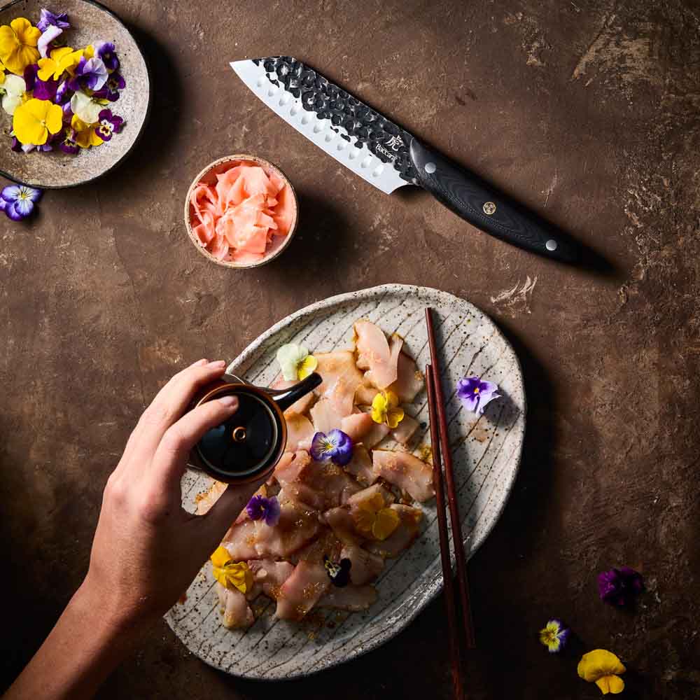 Woman pouring sauce on sashimi - Baccarat KUROI KIBA Santoku Knife 14cm at Baccarat