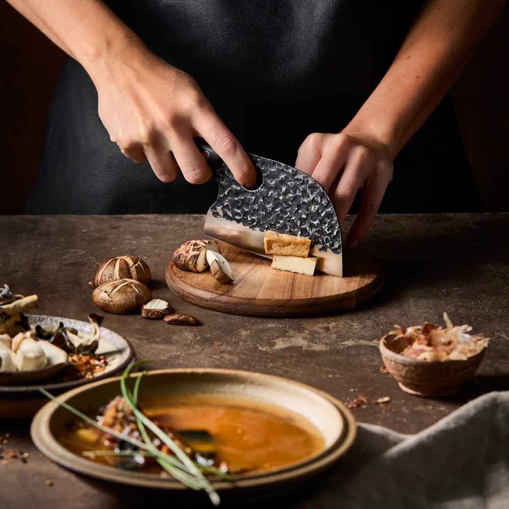 Woman slicing tofu with Baccarat KUROI KIBA Moon Knife 12.5cm at Baccarat