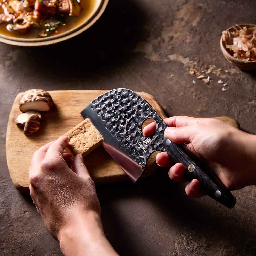Woman slicing tofu with Baccarat KUROI KIBA Moon Knife 12.5cm at Baccarat