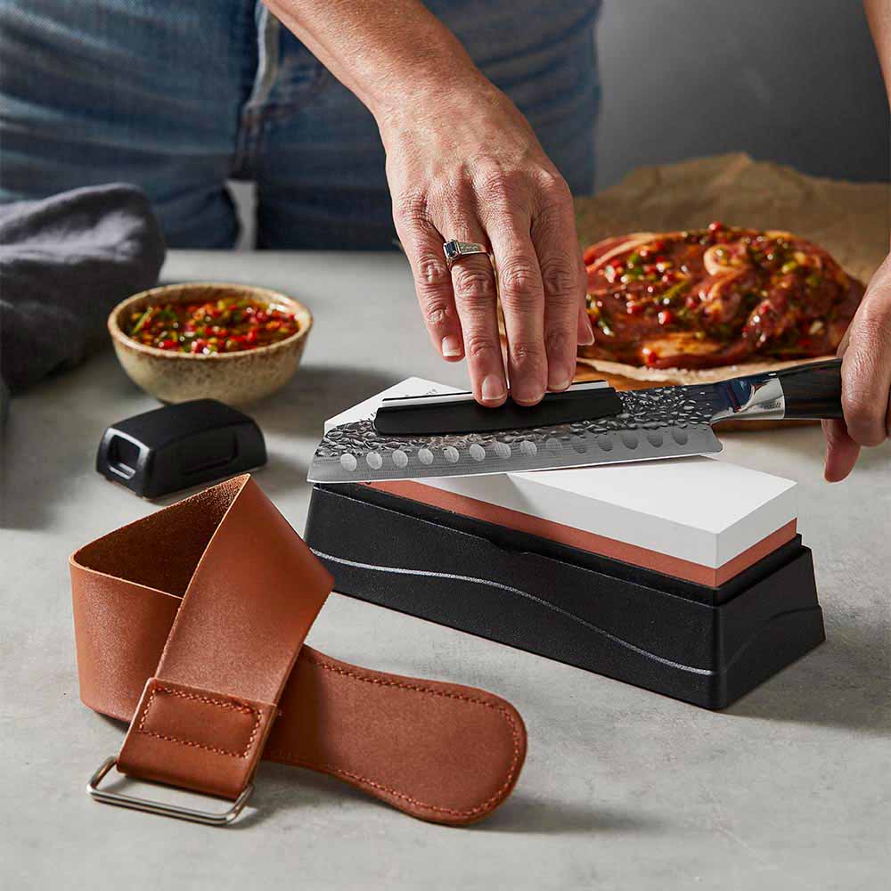 Woman sharpening knife with a whetstone - Baccarat