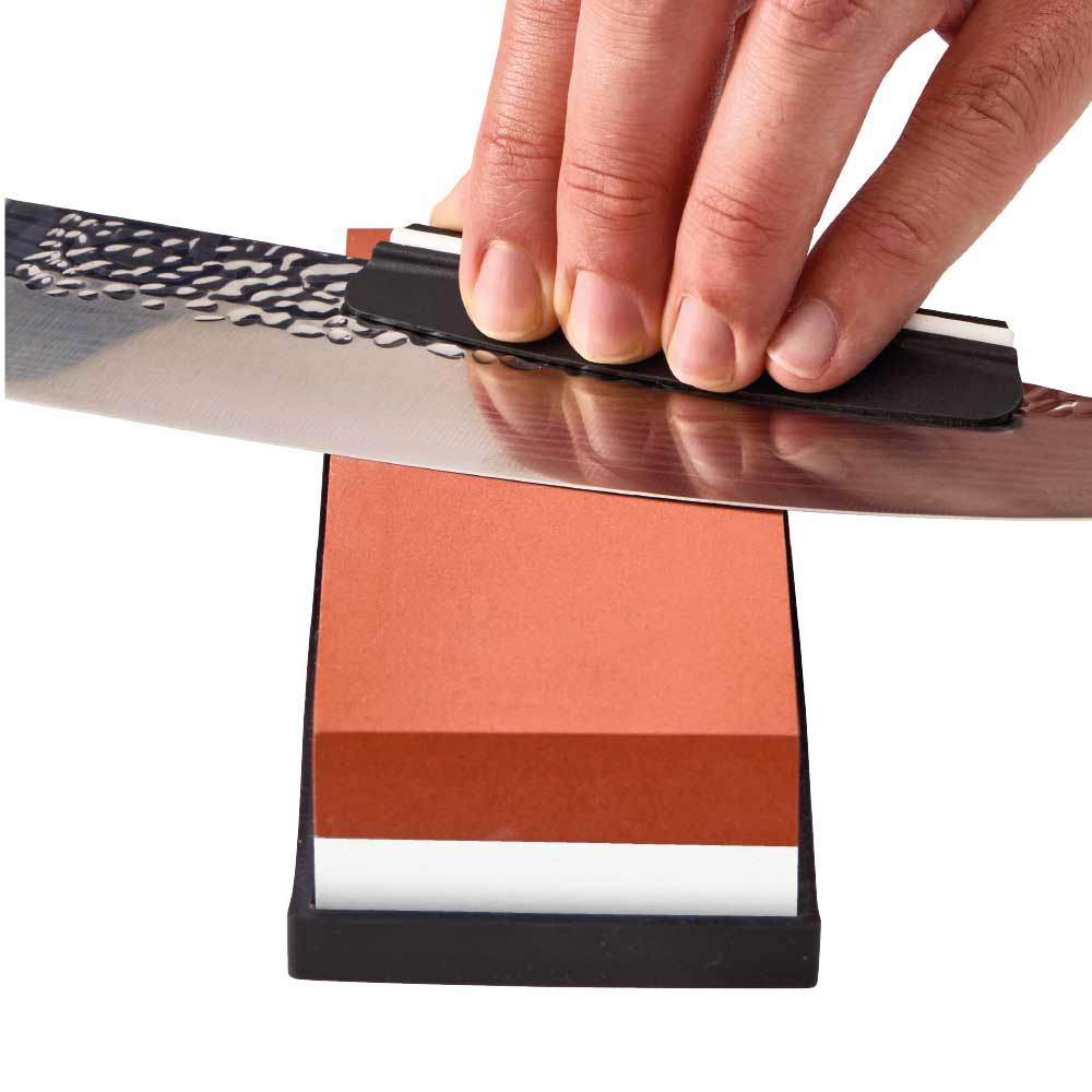 Man sharpening knife with whetstone - Baccarat