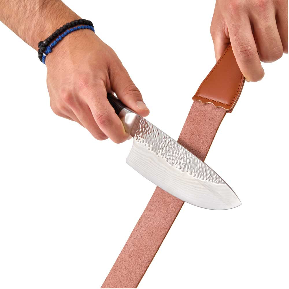 Man sharpening knife with leather strop - Baccarat