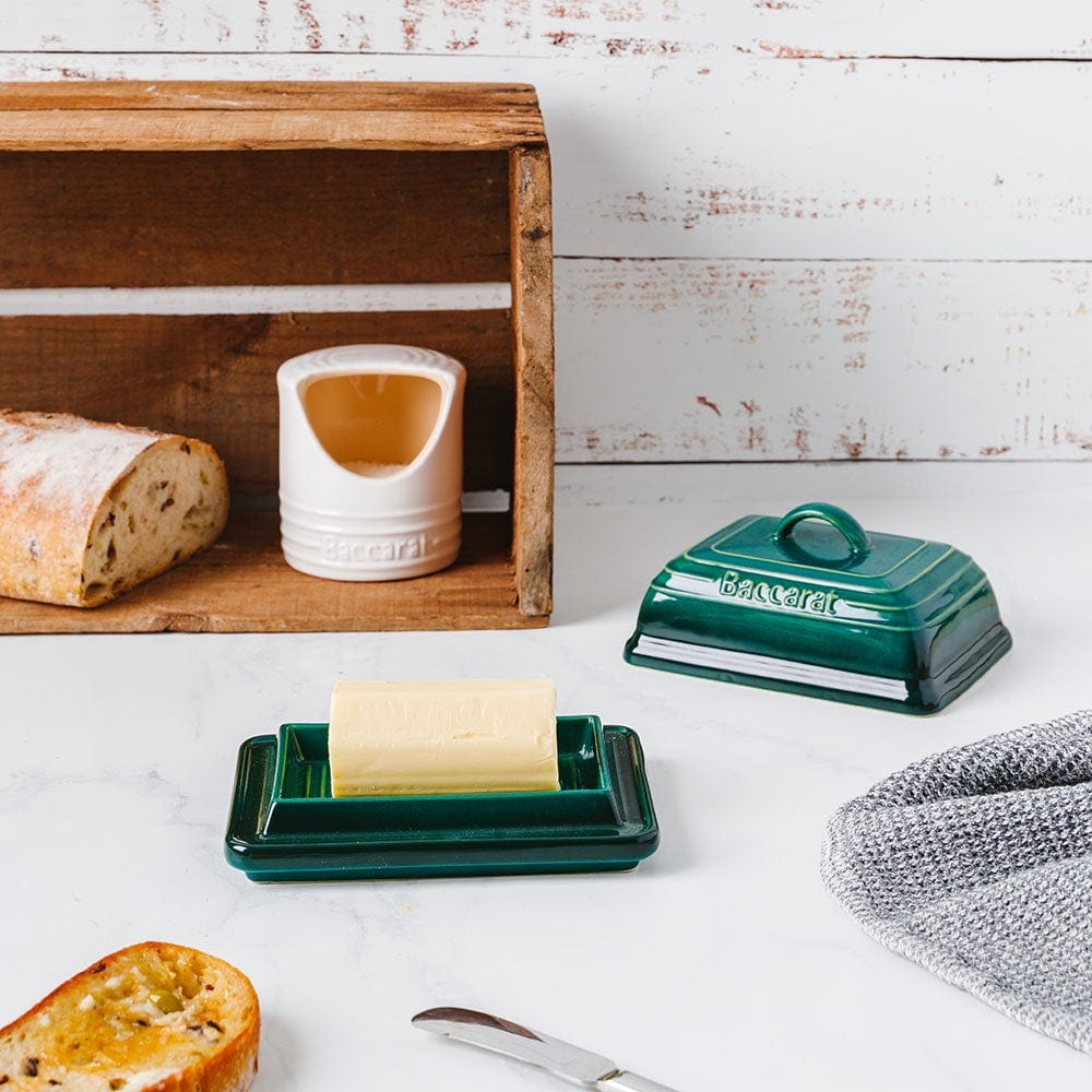 A teal butter dish on a white table with bread and a mug - Baccarat Le Connoisseur Stoneware